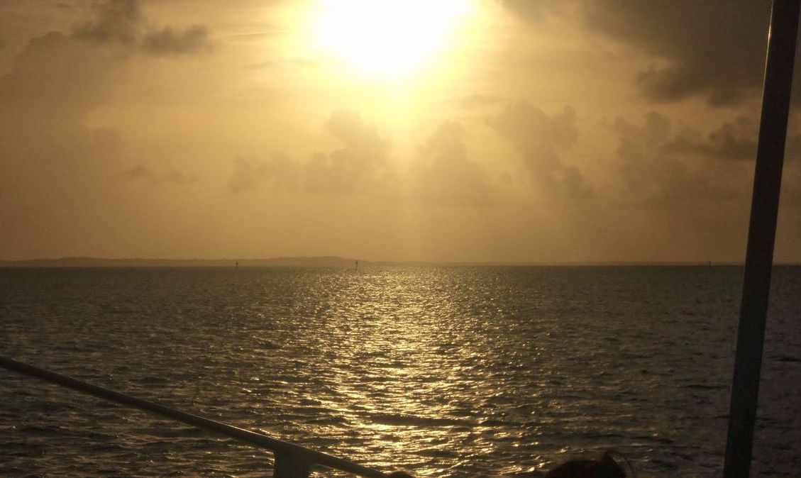 sunset at back of boat